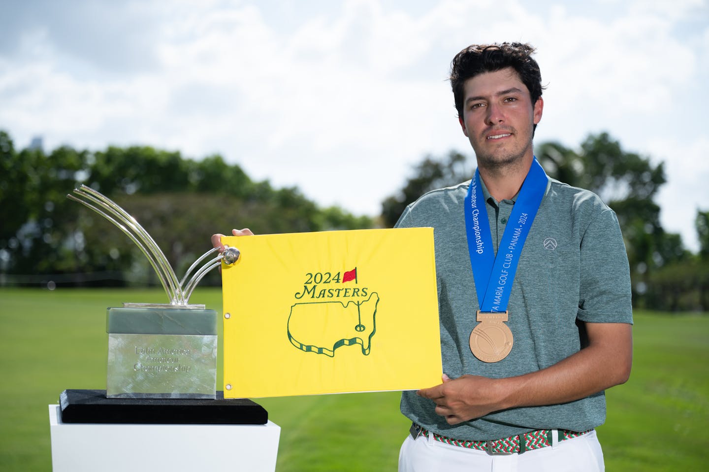 Santiago De la Fuente of Mexico poses with the LAAC Trophy and a Masters flag after winning the 2024 LAAC.